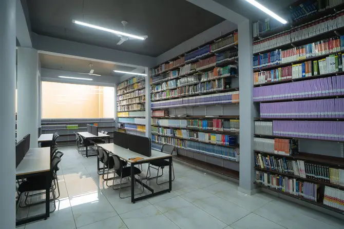 Spacious library with study tables and extensive book collections at a top MBA and management college in Ahmedabad Gujarat.