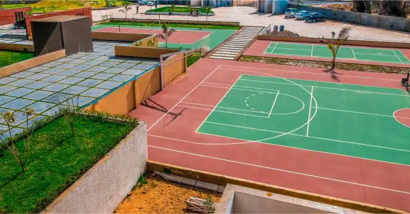 Outdoor sports facilities including basketball and multi-purpose courts at a top MBA college campus in Ahmedabad Gujarat.